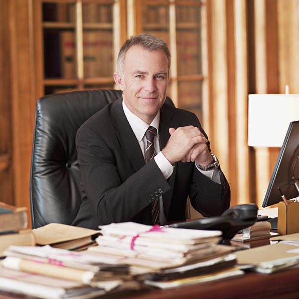 Smiling lawyer sitting at desk in office