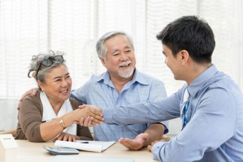 Older couple shakes hands specialist after estate planning in Colorado